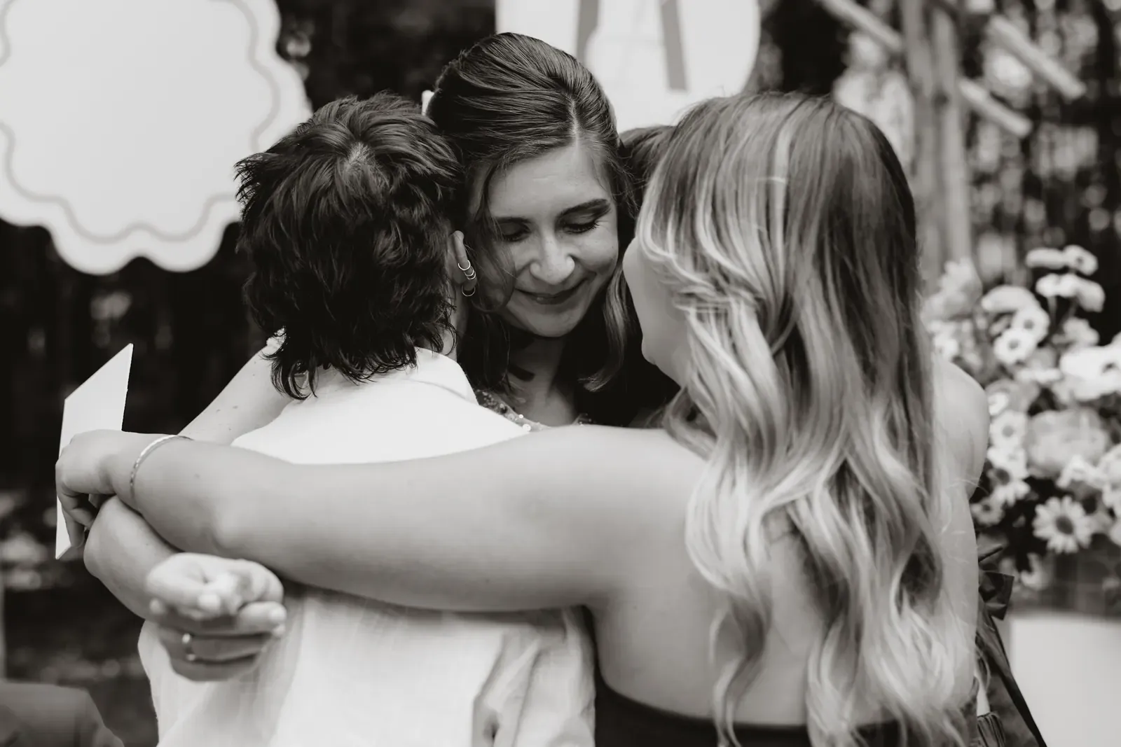 Guests embracing at the event, the designer among them rather than running the day