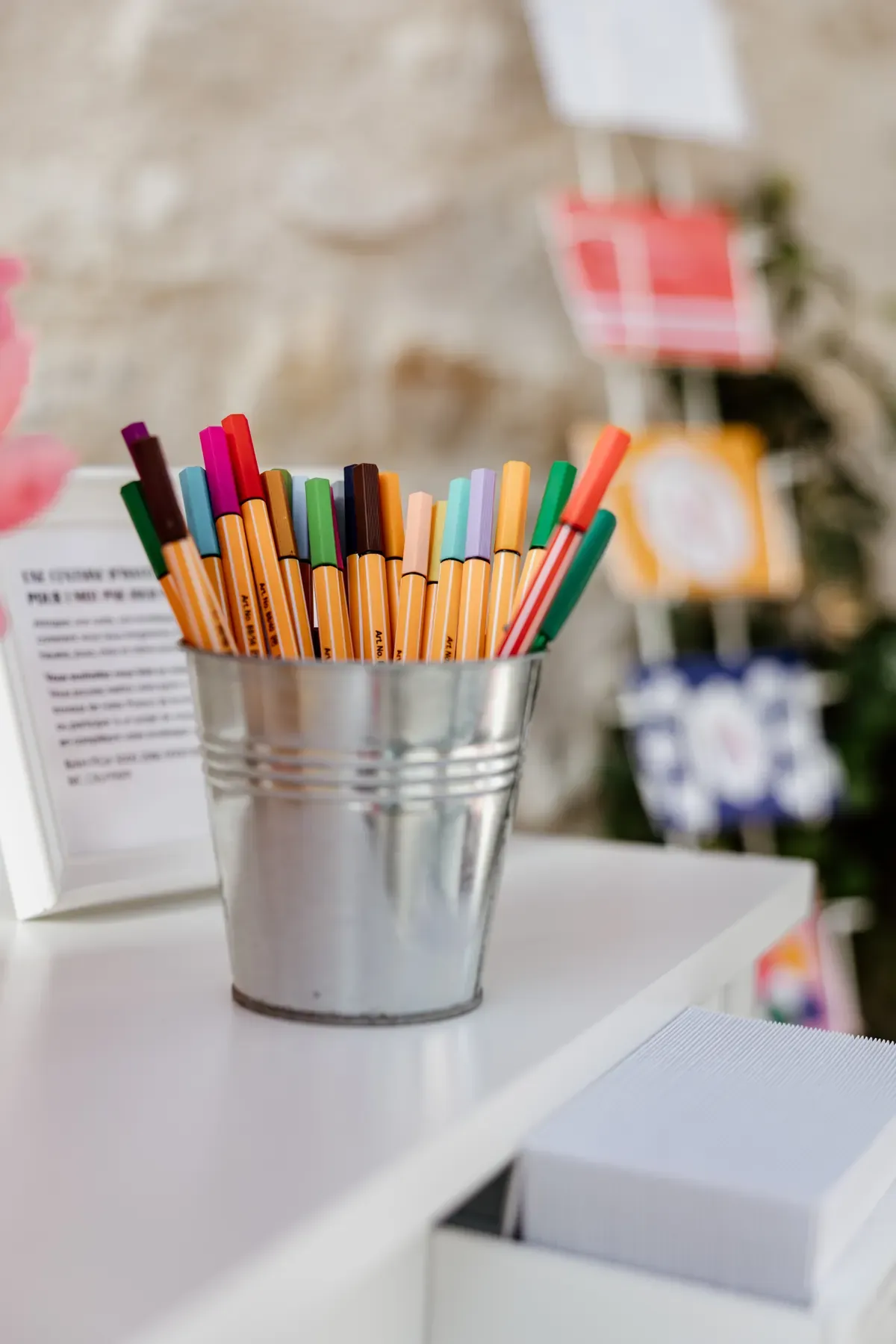 Writing desk set up for guests with coloured pens and a framed instruction card